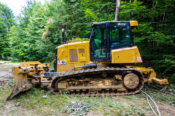 Fototapeta na wymiar Forest tractor for logging after sawing trees, heavy forestry equipment