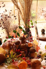 autumn image with boletus mushrooms, rosehips and leaves