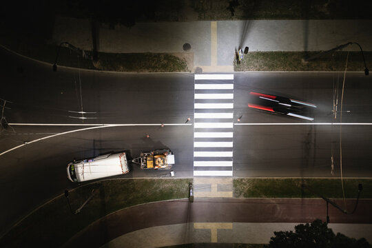 Aerial view of new pedestrian crossing zebra being painted on street in Kaunas.
