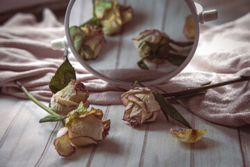 dried roses on wooden table