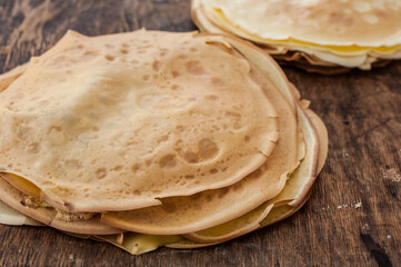 Pancakes close up. Pancakes on wooden background. A stack of pancakes on a wooden stand.
