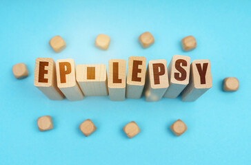 On a blue background, wooden cubes and Jenga with the inscription - EPILEPSY