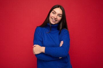 Fototapeta premium Photo shot of pretty joyful smiling young female person wearing casual trendy outfit standing isolated on colourful background with copy space looking at camera and having fun