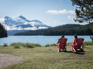couple sitting in front of the lake