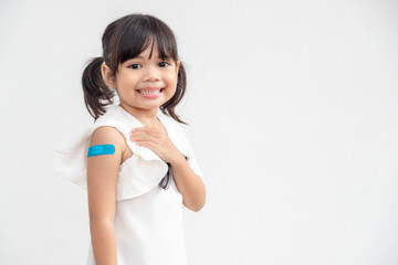 Asian little girl showing his arm after got vaccinated or inoculation, child immunization, covid delta vaccine concept - obrazy, fototapety, plakaty