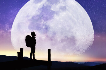 Landscape with Moon and Milky Way. Night sky with stars and silhouette of a standing happy women on the mountain, Success or winner, leader concept. High iso with Noise.