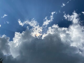 Sunburst visible from behind a dark cloud.