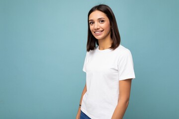 Portrait of positive cheerful fashionable smiling young brunette woman in casual white t-shirt for...