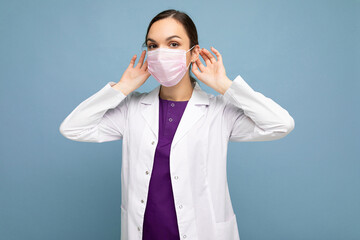 Young woman wearing an anti virus protection mask to prevent others from corona COVID-19 and SARS cov 2 infection isolated over blue background