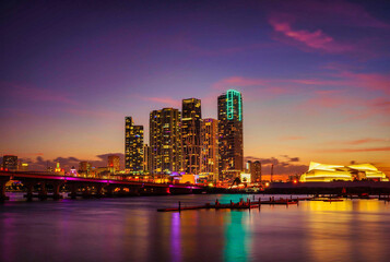 Fototapeta na wymiar city skyline at night beautiful colors miami downtown florida bridge skyscrapers sea reflections travel cute 