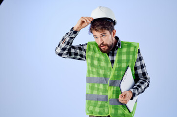 male worker in a green vestconstruction work design studio industry
