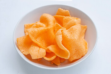Prawn crackers in white bowl on white background. Shrimp crispy rice snack
