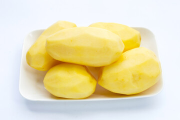 Raw peeled potatoes on white background