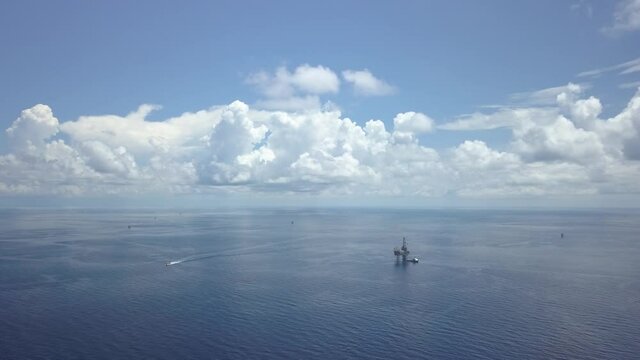Drone shot of offshore Jack up drilling rig in the middle of the ocean on sunny day
