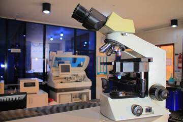 microscope with metal lens and cobas at laboratory