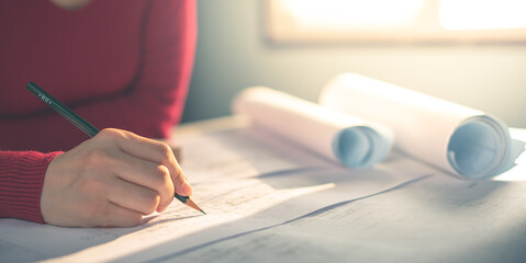 Architect working on blueprint. Architects workplace - architectural project, blueprints, ruler,...