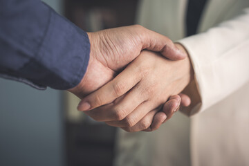 two businessman shake hand after complete success project with teamwork. close up of business man...