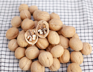 A lot of whole walnuts on a napkin close-up. Healthy, organic and healthy food with a high content of protein and protein.