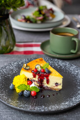 Delicious blueberries cheese cake well decorated with berries, mint and jam