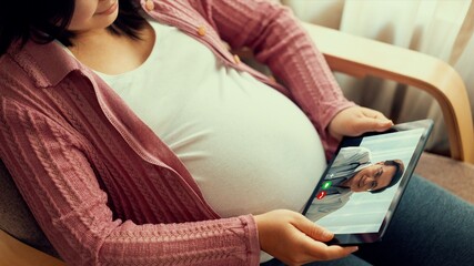 Doctor telemedicine service online video with pregnant woman for prenatal care . Remote doctor healthcare consultant from home using online mobile device connect to internet for live video call . - obrazy, fototapety, plakaty