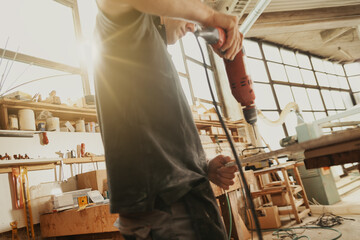 Carpenter preparing to drill a hole in a plank of wood