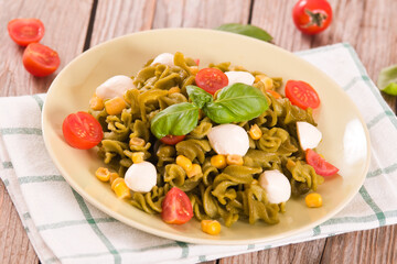 Fusilli pasta with cherry tomatoes and sweet corn.