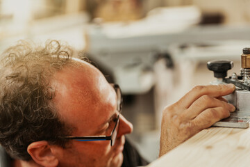 Artisan adjusting precision machinery in a workshop
