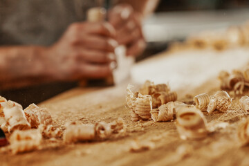 Fresh wood shavings and sawdust on a workbench