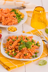 Fusilli pasta with peas and sweet corn.