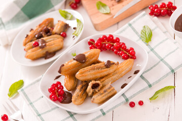 Mini churros with chocolate dipping sauce.