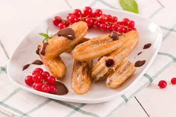 Mini churros with chocolate dipping sauce.