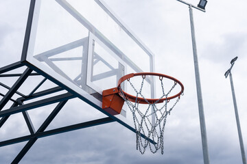 Basketball backboard with a ring, color photo processing. Black and white photo and ring highlighted in red. Focus on the basketball basket as a goal.