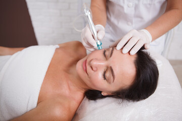 Naklejka premium Mature womn getting facial skincare treatment