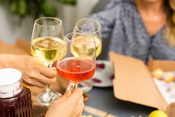 Clinking glasses with white wine and toasting