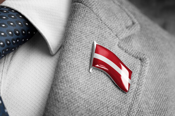Metal badge with the flag of Latvia on a suit lapel