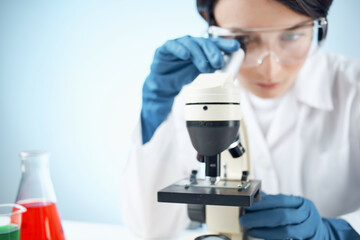 Woman in white coat laboratory science microscope
