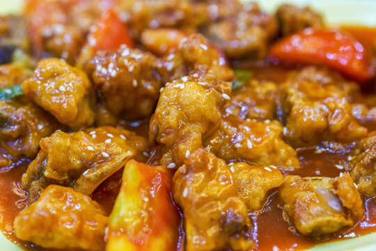 Closeup of a delicious sweet and sour pork ribs in tomato sauce