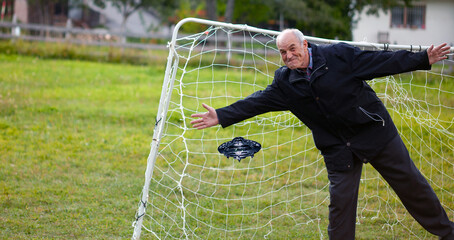 old man play in soccer place 