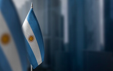 Small flags of Argentina on a blurry background of the city