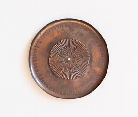 Mid-century modern copper wall plate - isolated on white wall