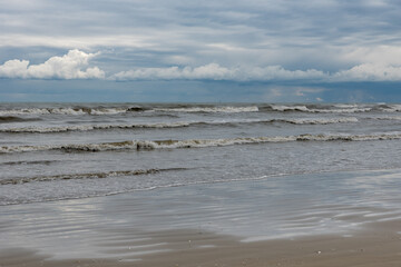 Winter seashore with clouds and waves