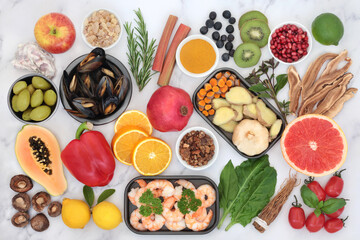 Healthy food for immune system support with seafood, vegetables, fruit, herbs and spice. Health foods very high in antioxidants, anthocyanins, protein, fibre, vitamins, lycopene, minerals and omega 3.