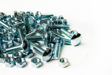 pile of bolts and nuts on white background with copy space