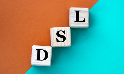 DSL- acronym on wooden cubes on a multi-colored background
