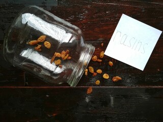 raisins in the jar and near the jar and a sheet with raisins written on it