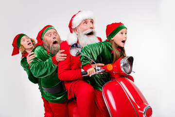 Photo of amazed speechless team four people drive moped party wear santa elf costume isolated grey...