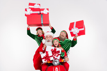 Photo of four party people ride bike hold presents wear santa elf costume isolated white color...