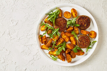 vegan lentil patties with baked potato and hummus