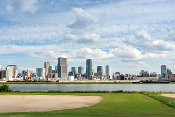 Fototapeta premium View of office buildings of central Osaka city from Yodogawa river bank