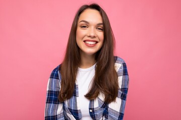 Fototapeta premium Portrait of positive cheerful fashionable woman in hipster outfit isolated on pink background with copy space